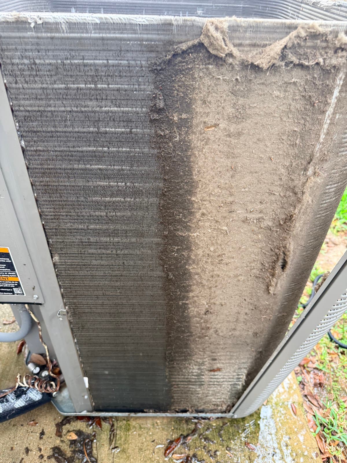 Condenser coil half-cleaned by Pristine Air, showing dramatic before and after