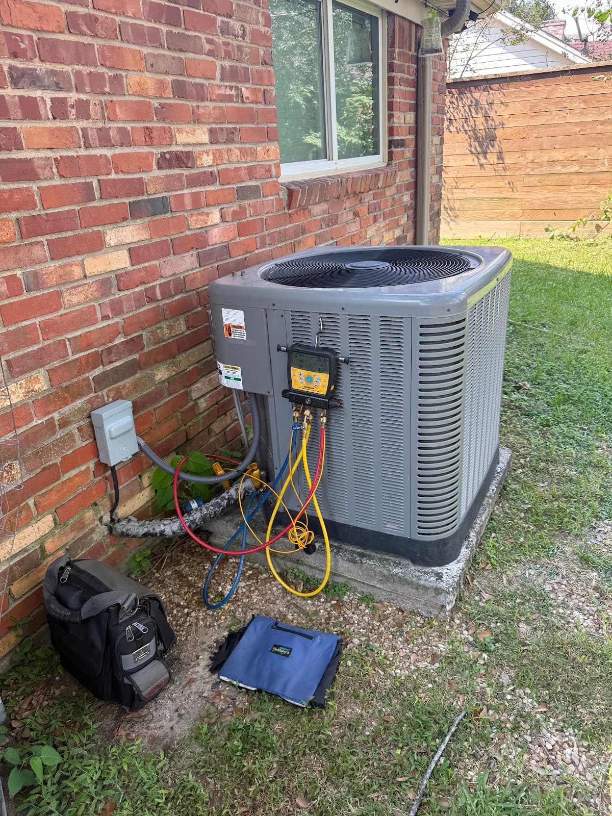 Pristine Air servicing an outdoor AC condenser unit in Conroe, TX